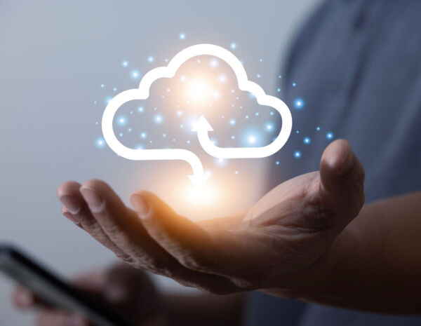 A man holds a virtual representation of cloud computing in his hand.